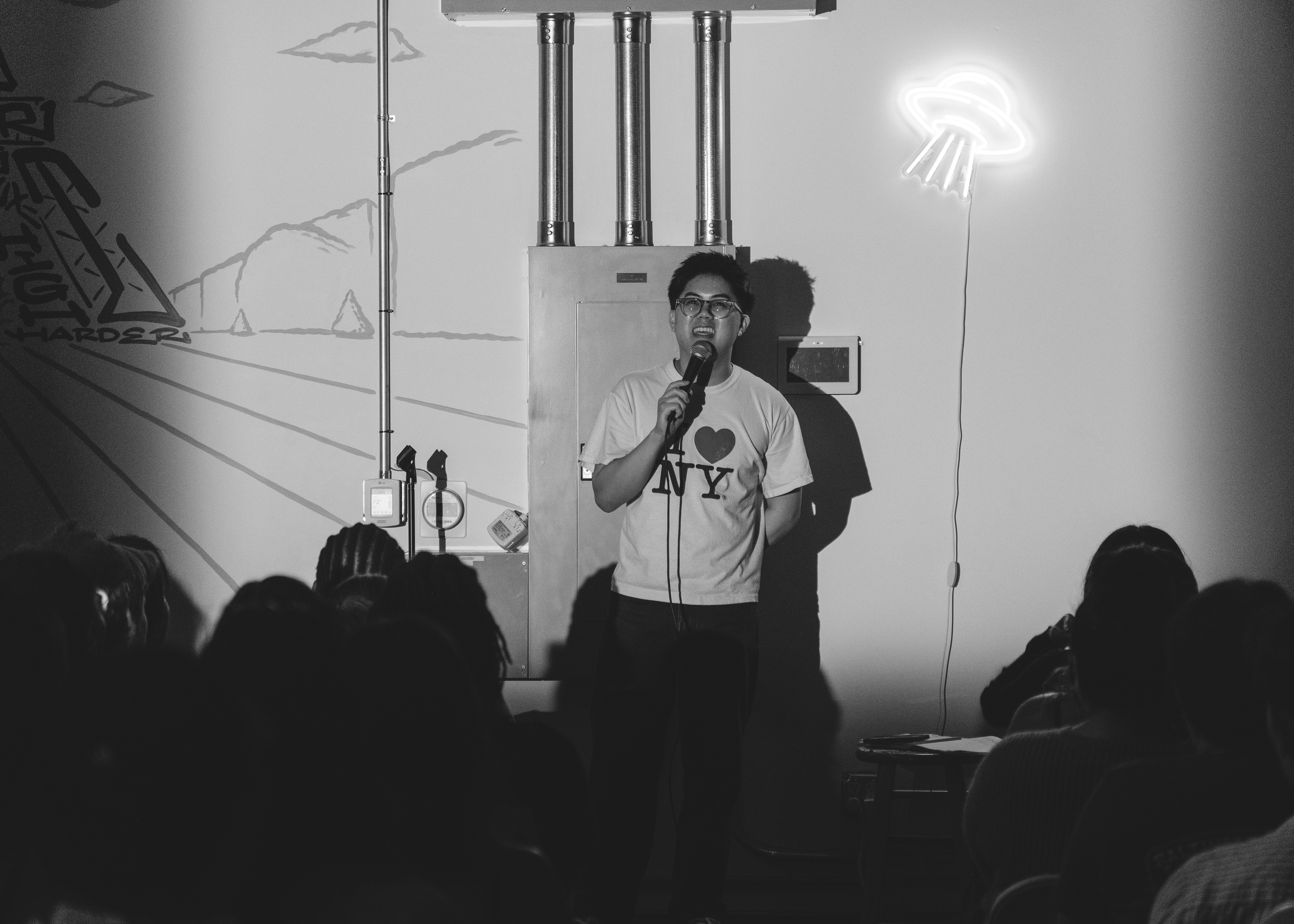 Comedian performing on stage at Spaced Out Comedy