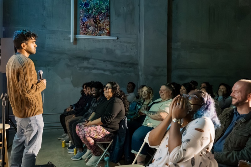 Comedian performing to a laughing crowd at Spaced Out Comedy in San Jose