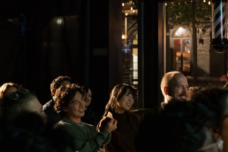 Audience members smiling and laughing at Spaced Out Comedy